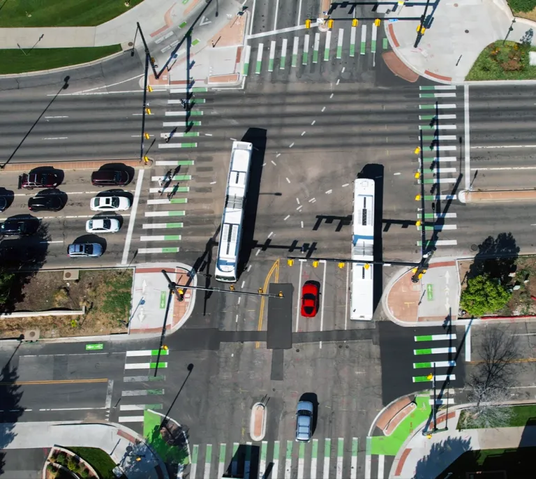 28th and Colorado intersection from above. Buses, cars, bikes and people walking travel. 