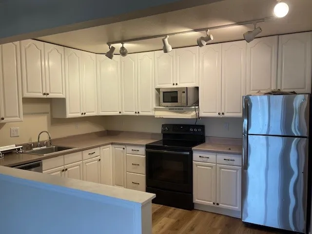 3150 Iris Ave #F211 - kitchen with new appliances painted cabinets new flooring