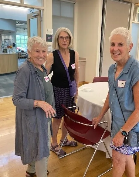 Three women gather to chat at the Ice Cream Social