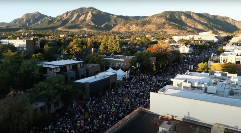 Aerial view of downtown Boulder with runners lined up for a race