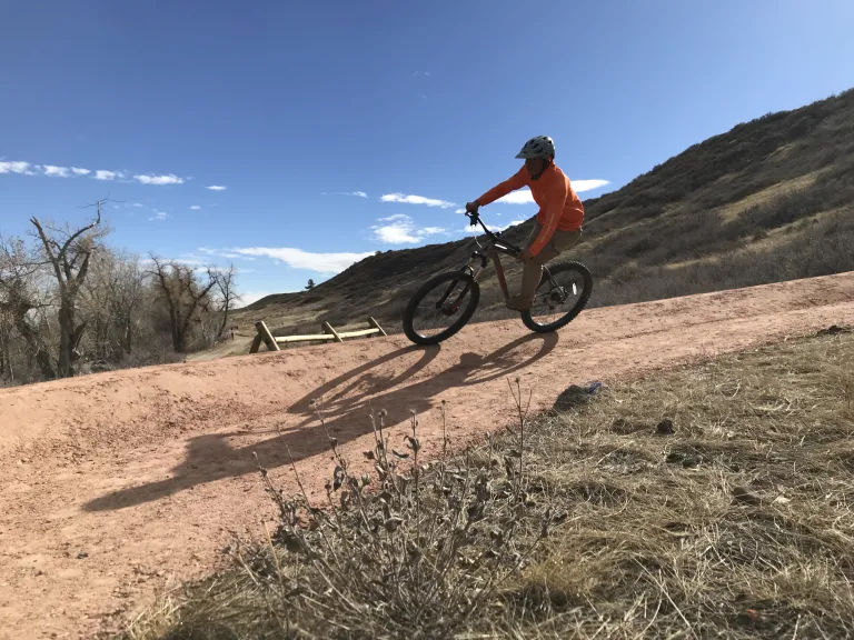 Mountain biker riding down a curved trail section