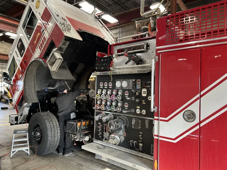 A City of Boulder fire engine undergoing maintenance or repairs in the fleet garage.