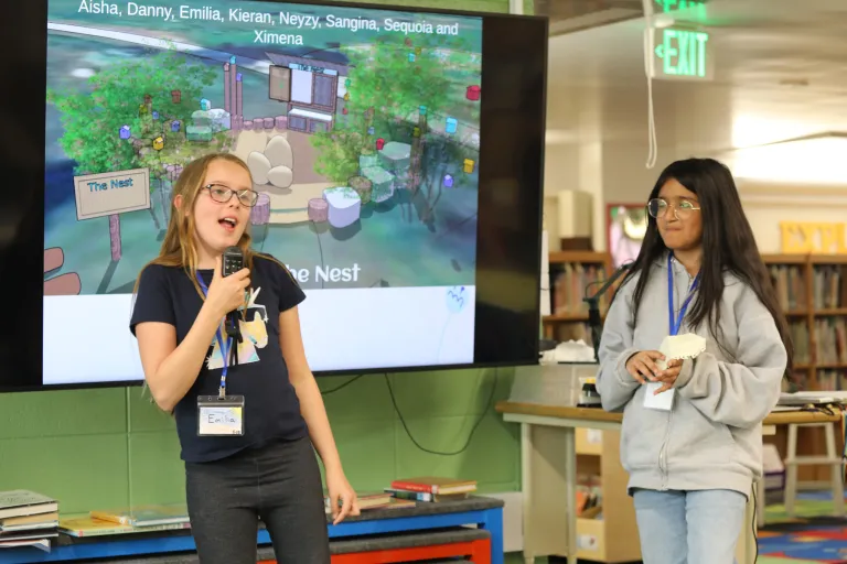 Two students give a presentation about The Nest.