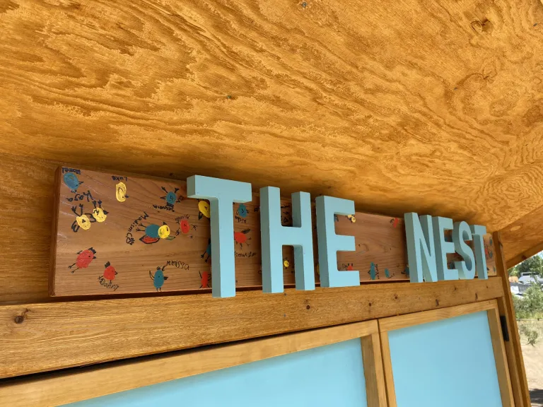 A close-up view of The Nest sign.
