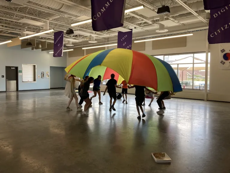 Amico campers playing a parachute game