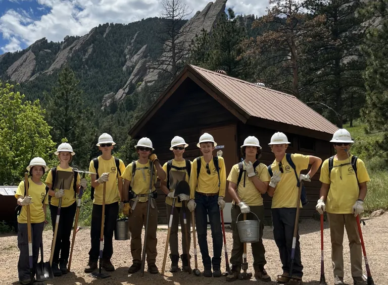 Junior Ranger crew poses in front of Flatirons