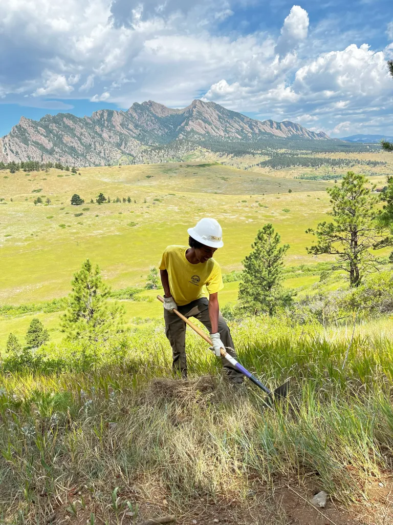 Junior Ranger starts the cut of a new trail