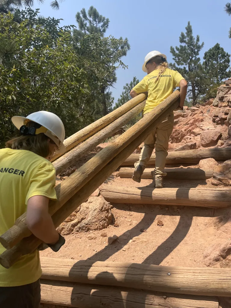 Junior Rangers haul fence logs up Mount Sanitas