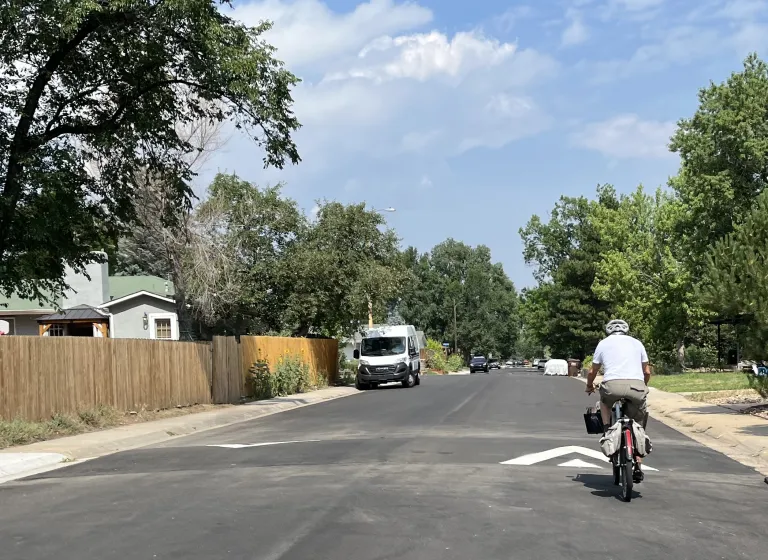 A bicyclist riding over a speed hump on Martin Drive