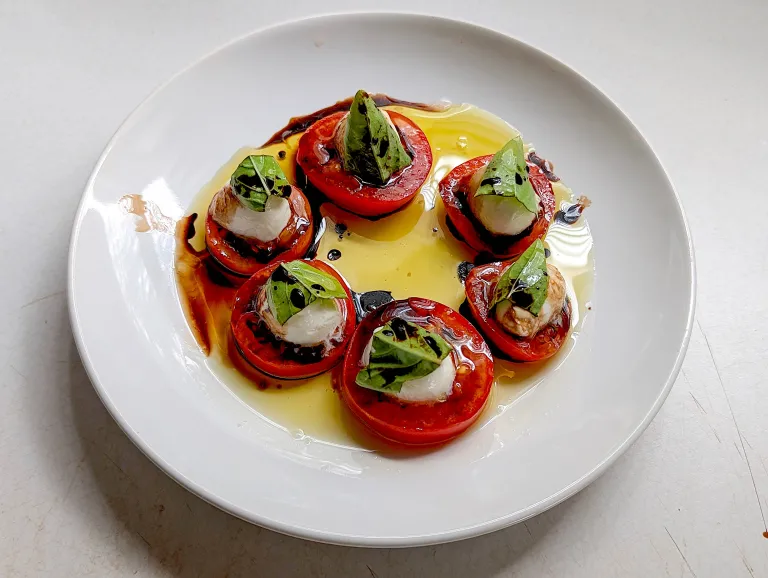 Caprese salad on a white plate. 