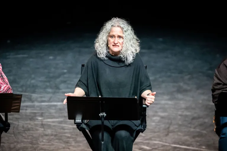 Elevate Boulder participant on stage during their monologue performance at Motus Theater.
