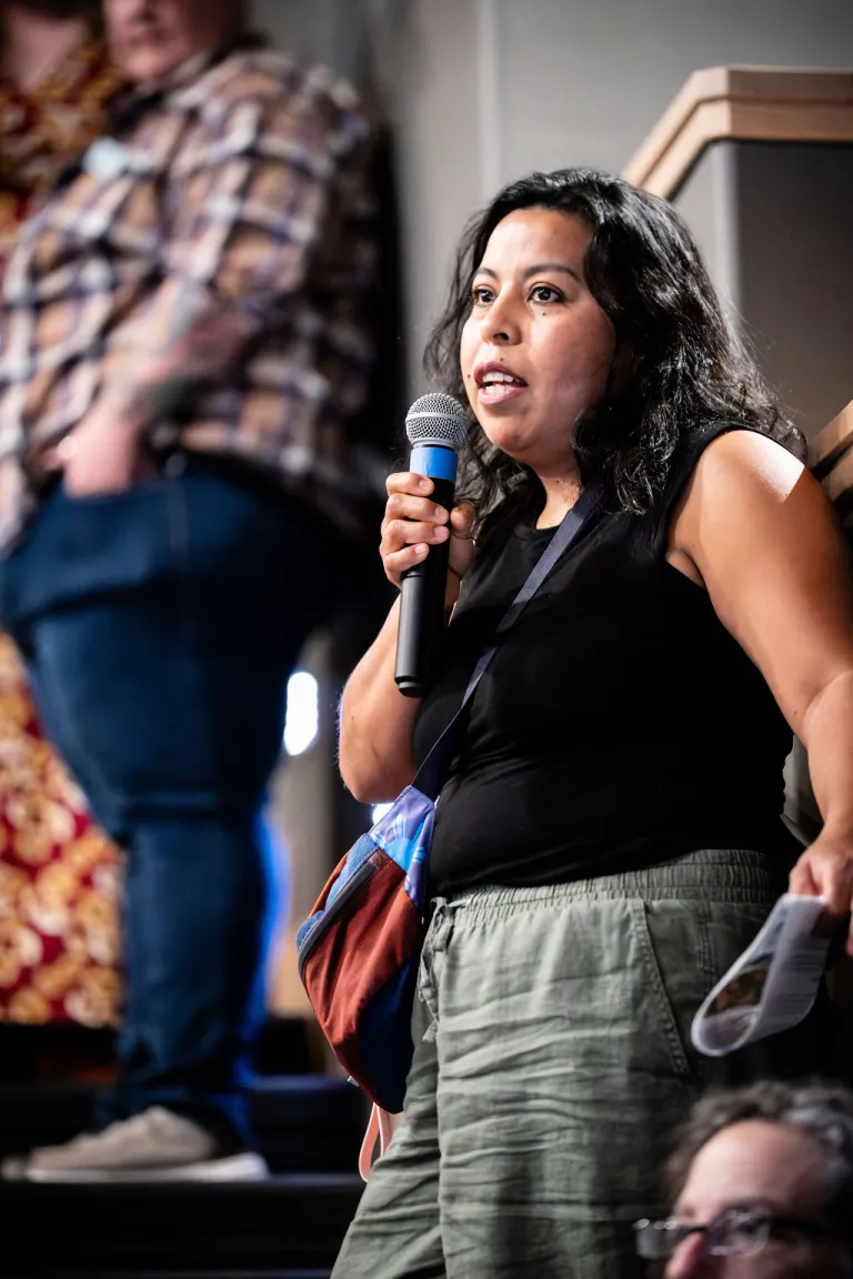 Audience member asking a question during the Elevate Boulder monologue performance at Motus Theater.