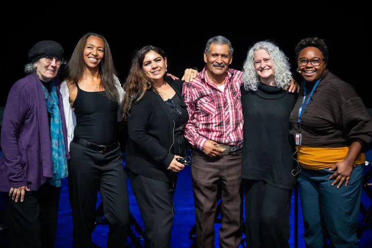 Group of six Elevate Boulder participants posing on stage after their monologue performance at Motus Theater.