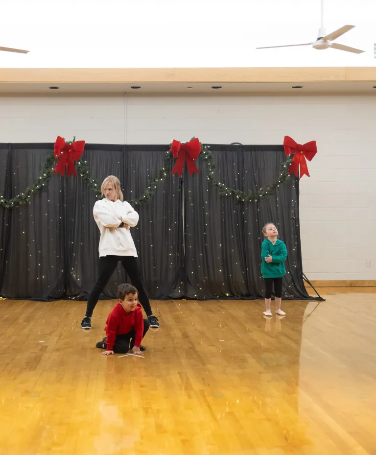 2 kids 1 adult dancing on stage