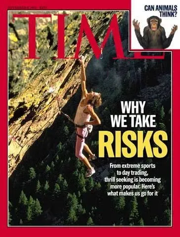 TIME Magazine cover titled Why We Take Risks showing a climber hanging off a rock formation.