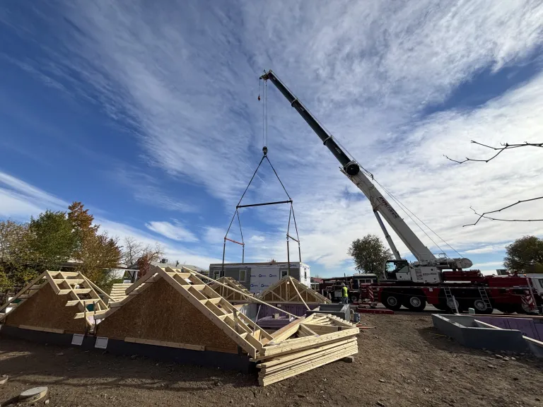 First section of modular home being lifted off the truck. 