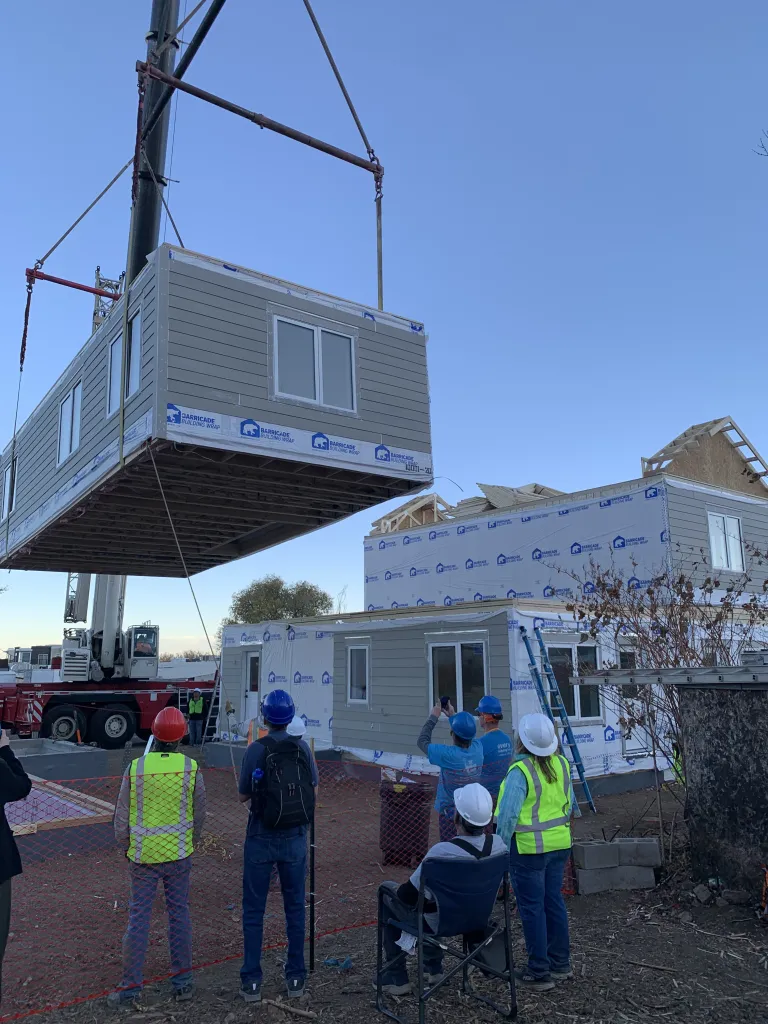 Last section of the modular home lowing into place. 