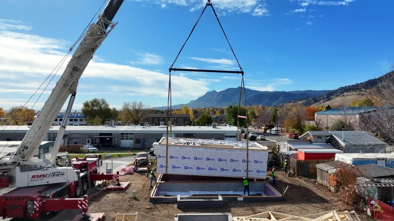 First section of modular home being placed on the foundation. 