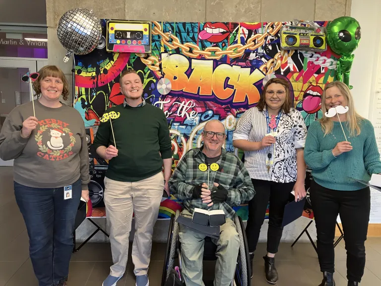 City staff at a photobooth at an employee event