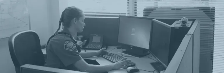 Boulder police officer working at a computer
