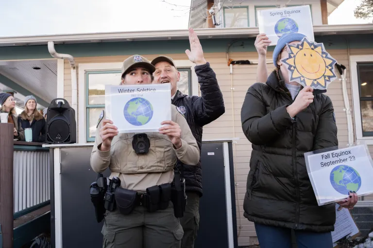 Rangers holding pictures of the earth from different angles