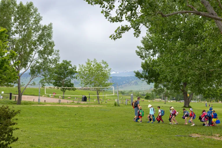 Campers following staff at a park