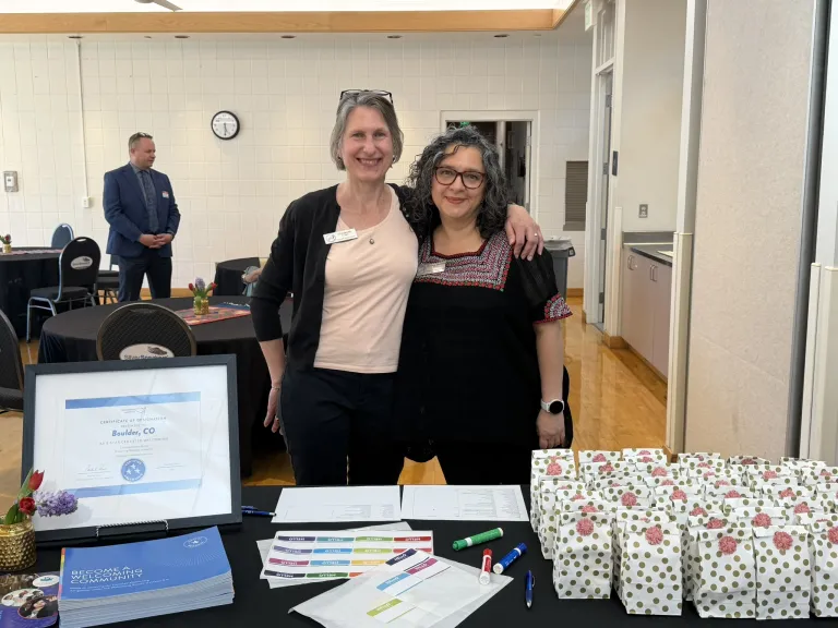 City staff members posing behind the welcome table for the event