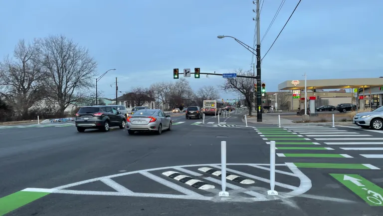 paint and post protecvted interim intersection with green bike crossing and pedestrian crossings in white paint