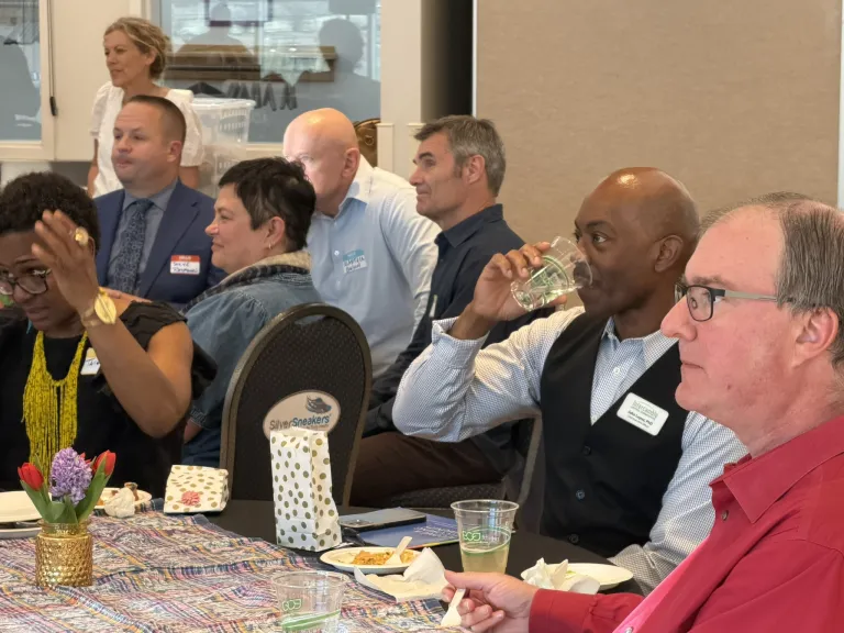 left profile of multiple tables of event participants including city staff, elected officials and partner organizers