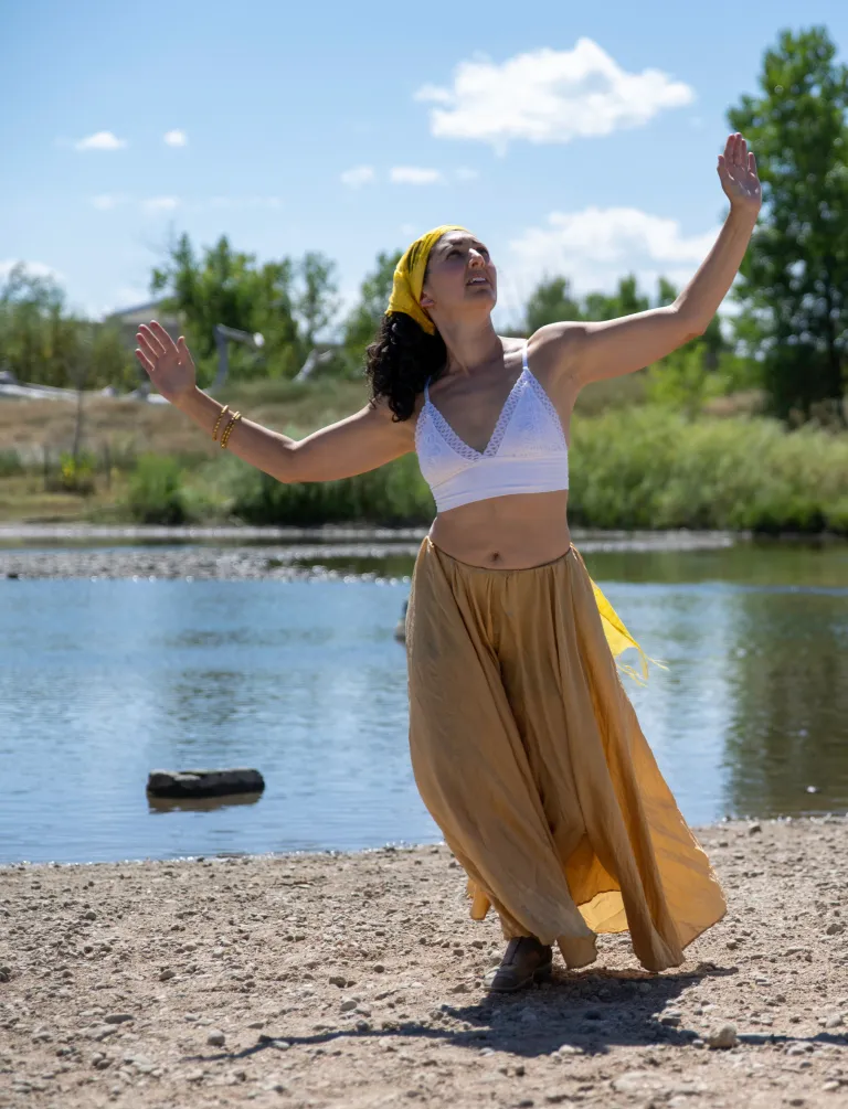 Afro-Brazilian dancer by a small pond