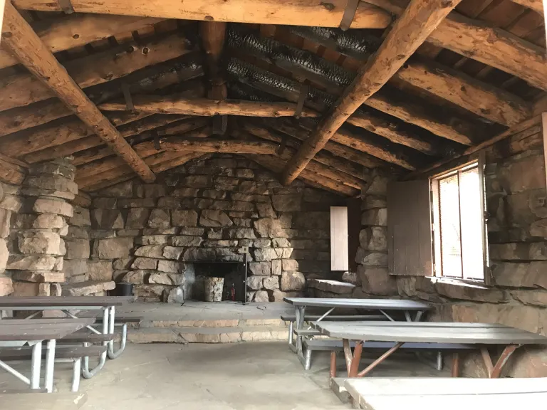Inside the Halfway House with stone walls and large wooden beams on the ceiling.