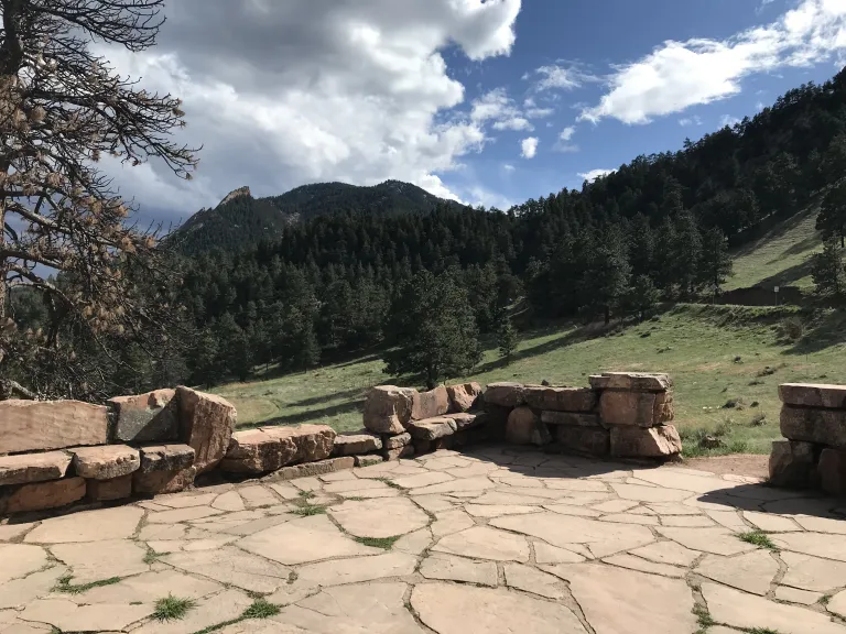 The Halfway House flagstone patio with the Flatirons in the background.