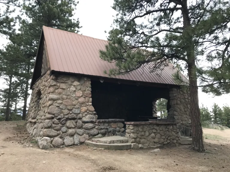 The Stone Shelter, a stone building with an open front, two side windows and a metal roof.