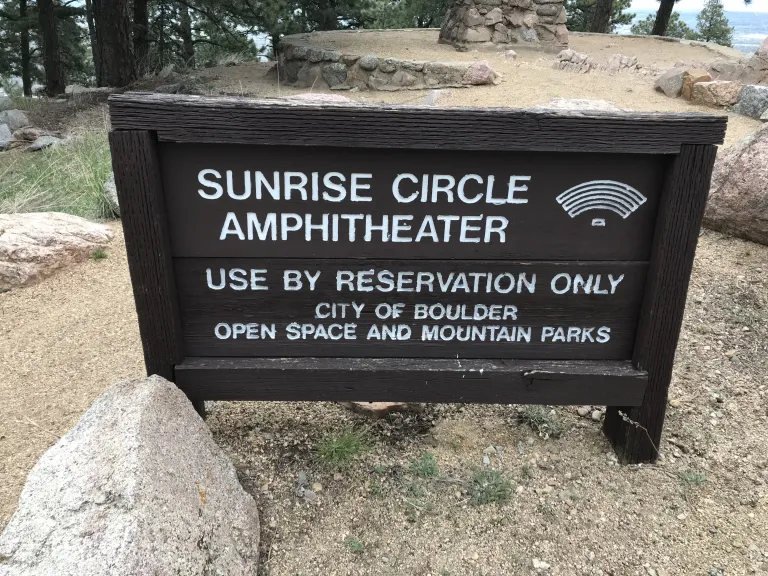 The sign states: Sunrise Circle Amphitheater, use by reservation only, City of Boulder Open Space and Mountain Parks.