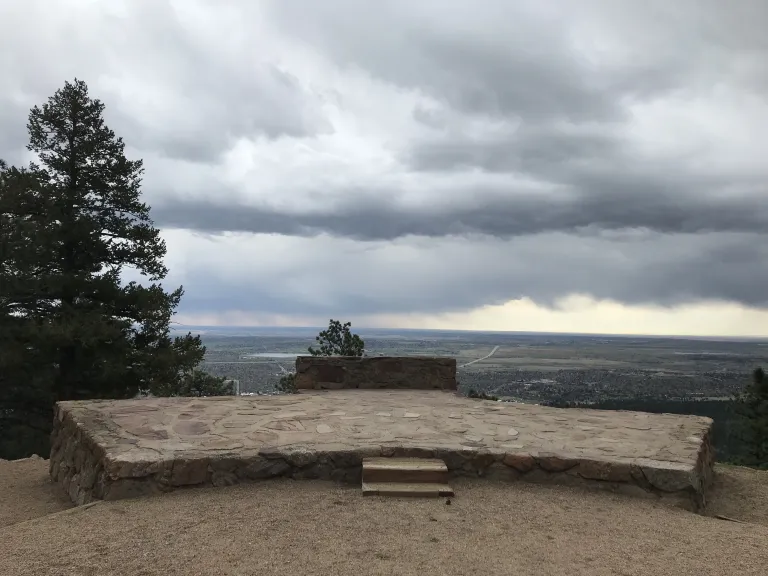 The Sunrise Amphitheater stone stage with a view down to Boulder in the background.