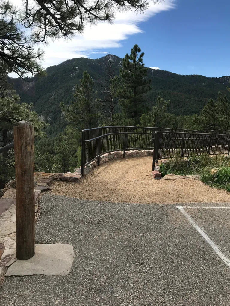 The dirt ramp down to the Sunrise Amphitheater starts from the paved parking area.