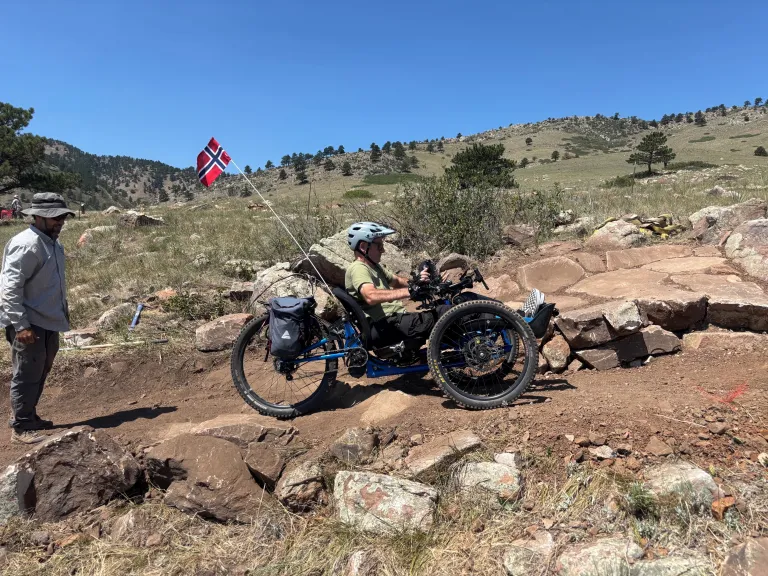 An adaptive mountain bike rider testing out a new section of North Foothills Trail.