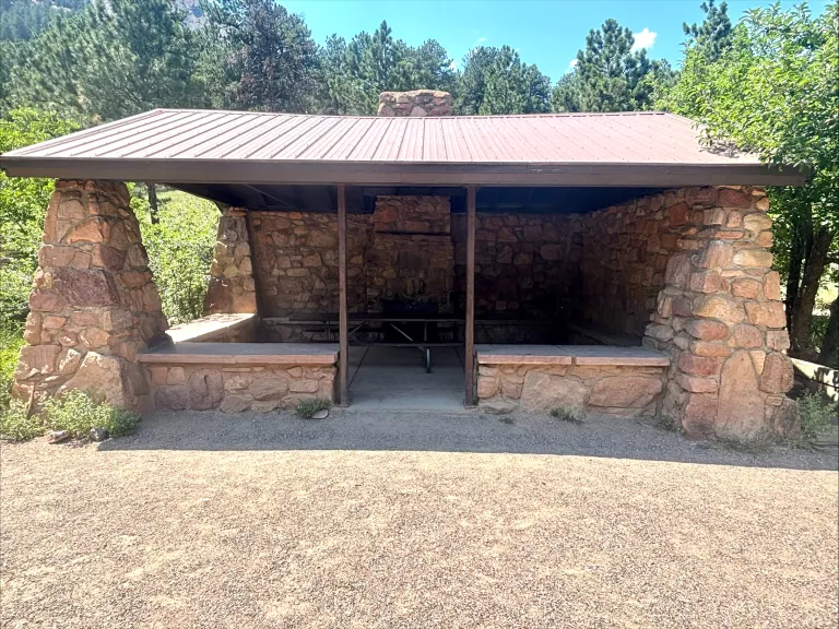 A close-up view of the front of the open-air, stone Bluebell Shelter.