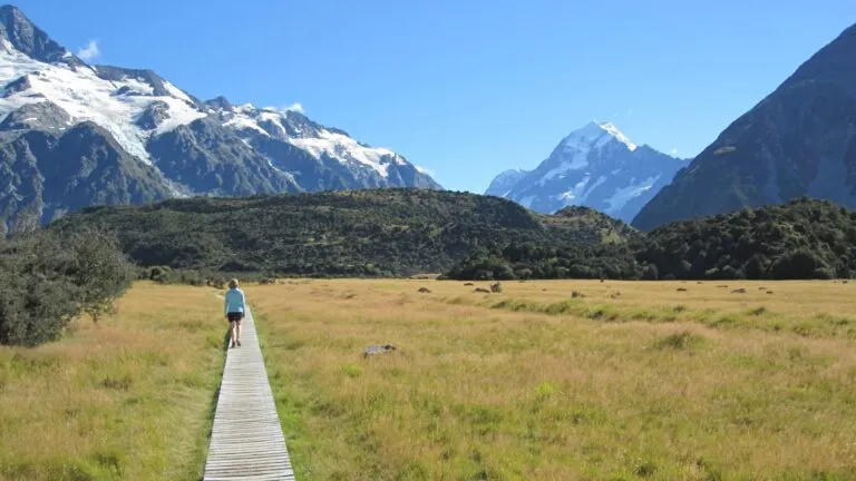  Elizabeth Judd on a mountain meadow boardwalk with peaks in the distance