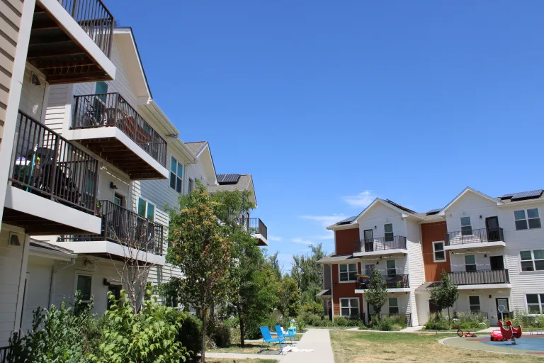 Apartments with a grassy lawn in the middle.