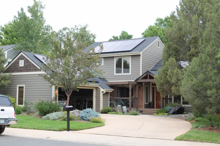 Home with solar panels and an open garage.