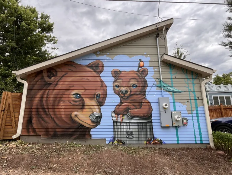 Mural of two bears on the side of a garage