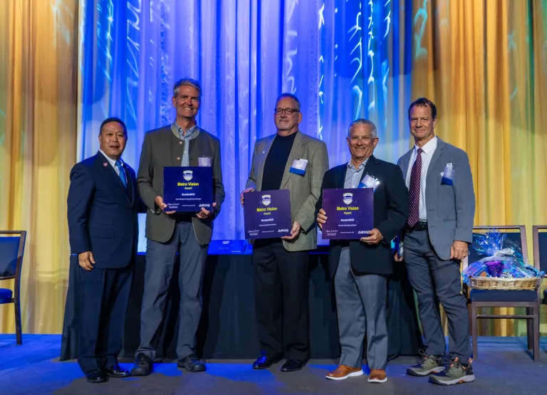 Representatives from the City of Boulder, BVSD and Flatirons Habitat accept BoulderMOD's Metro Vision Award.