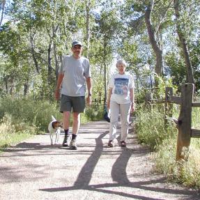 Couple Hiking along Trail with Dog