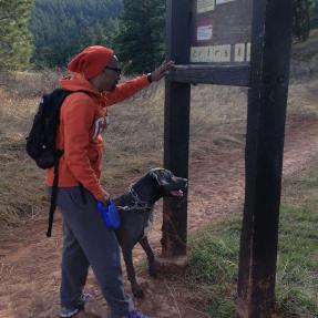 Woman looking at reg board with her dog
