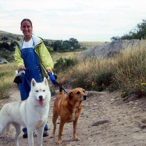 Woman hiking with two dogs
