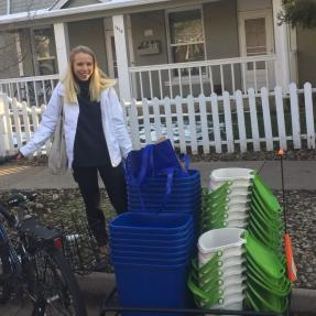 An EcoVisits volunteer delivers compost bins to community members