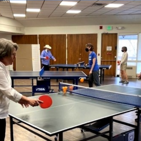Older adults playing table pong at the West Age Well Center