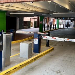 Photo of the entrance to the BoulderPark Garage at 11th and Spruce streets, showing the gates and ticket payment kiosk