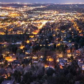 an aerial view of warm lights in Boulder at night